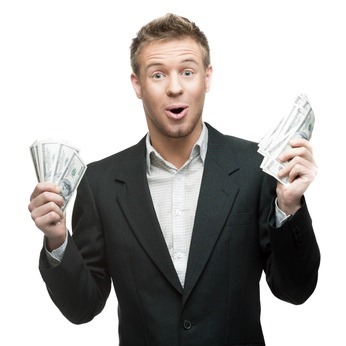 young surprised businessman holding money